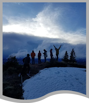 Students stand on a snowy mountain