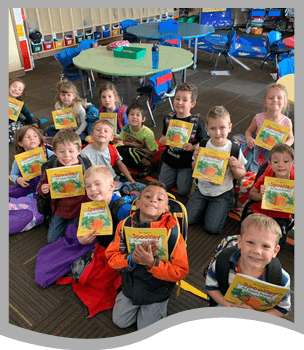 Classroom of students holding books