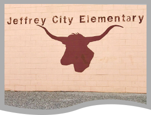 Jeffrey City Elementary sign and longhorn outline on a brick wall