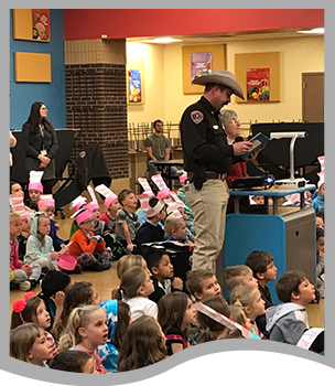 Police officer reads to students
