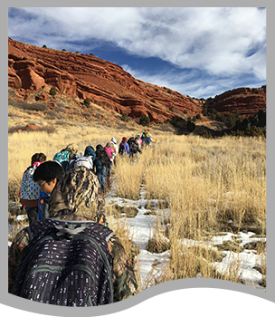 Students walk toward a canyon