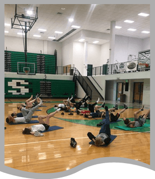 Students participate in a yoga class
