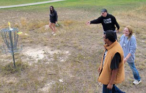 Students playing frisbee golf