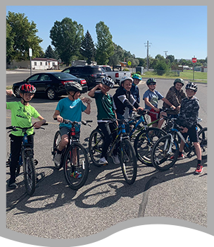 Middle school student outside with their bike team